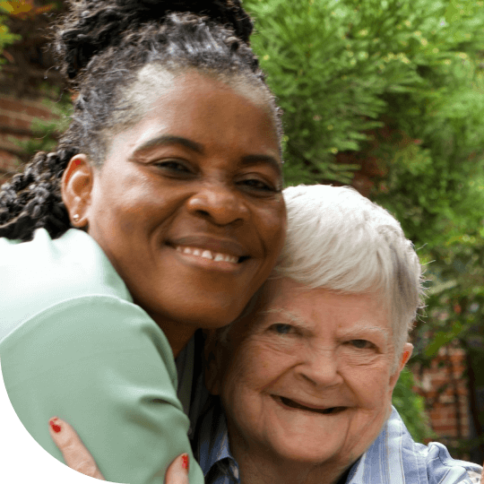 Two people hugging and smiling